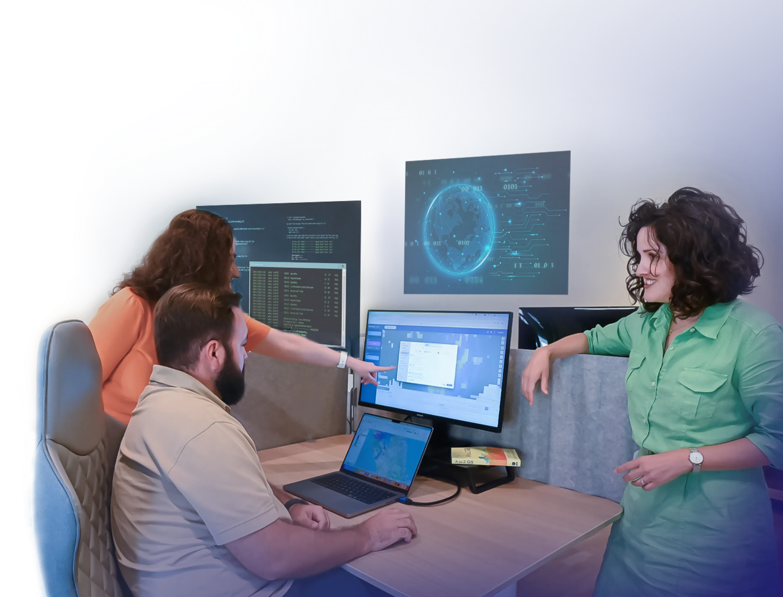 GIS developers working together and looking at a computer screen.