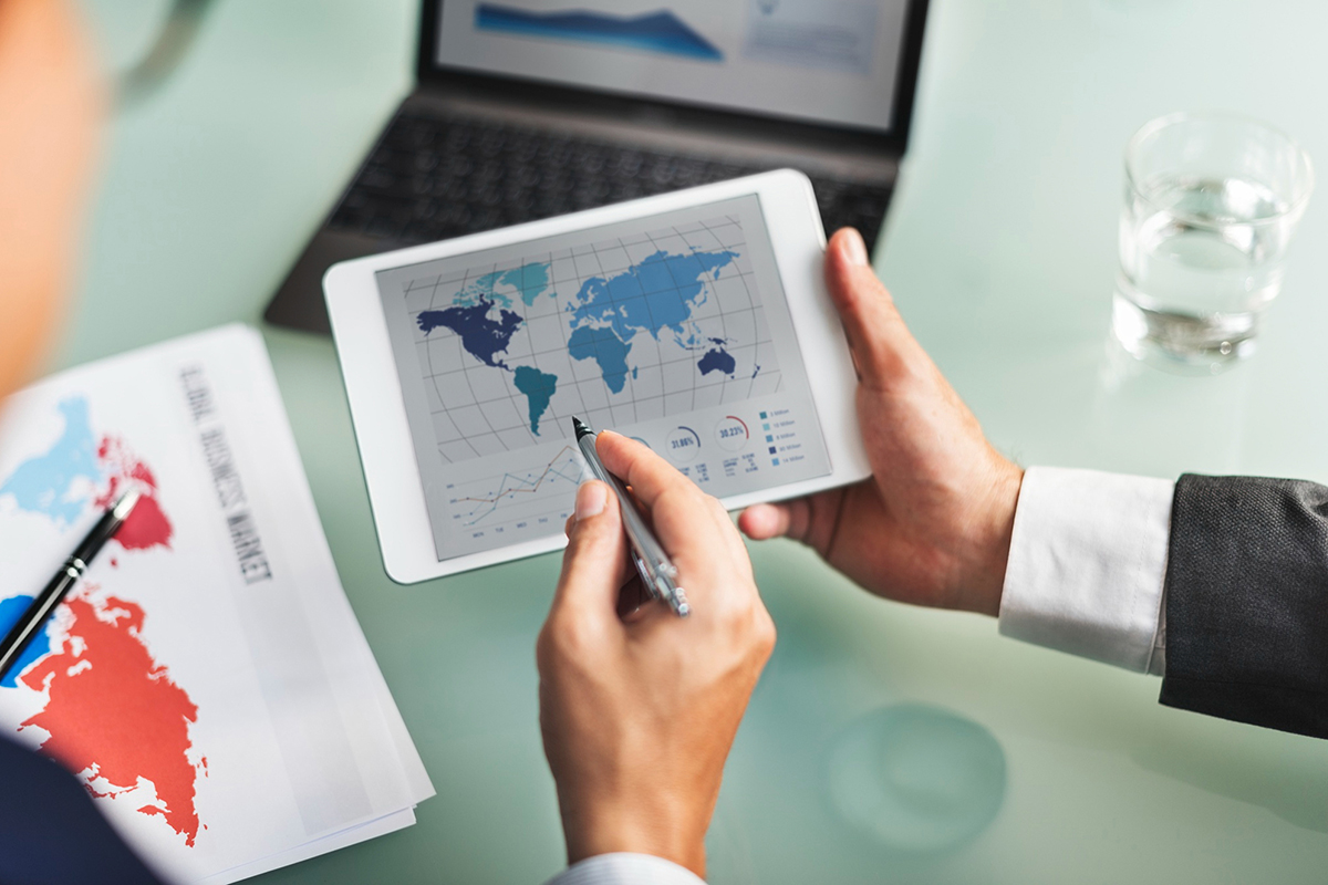 Two people pointing at tablet with a map on the screen