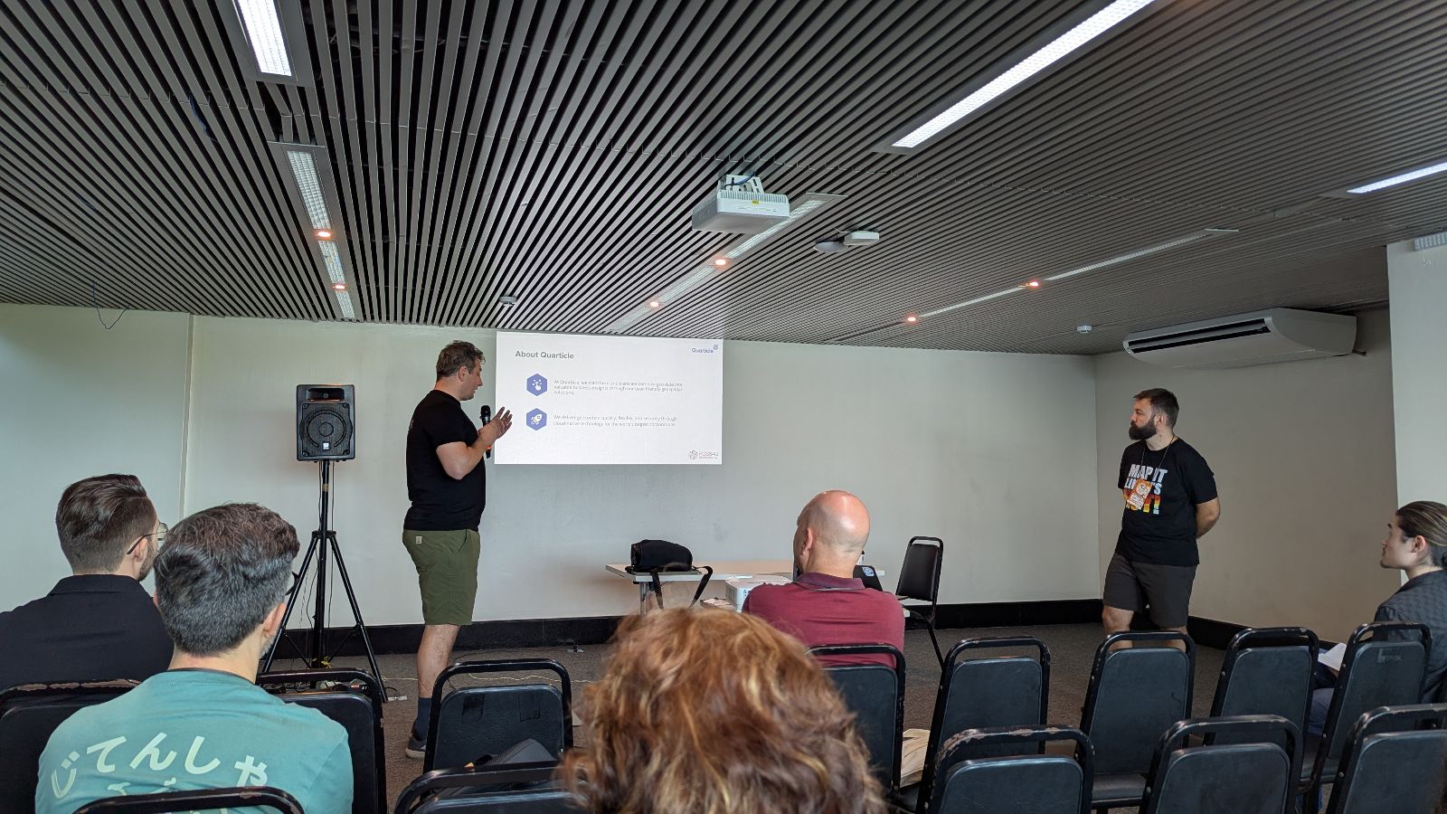 Two members of the Quarticle team giving a technical presentation at FOSS4G Belem.