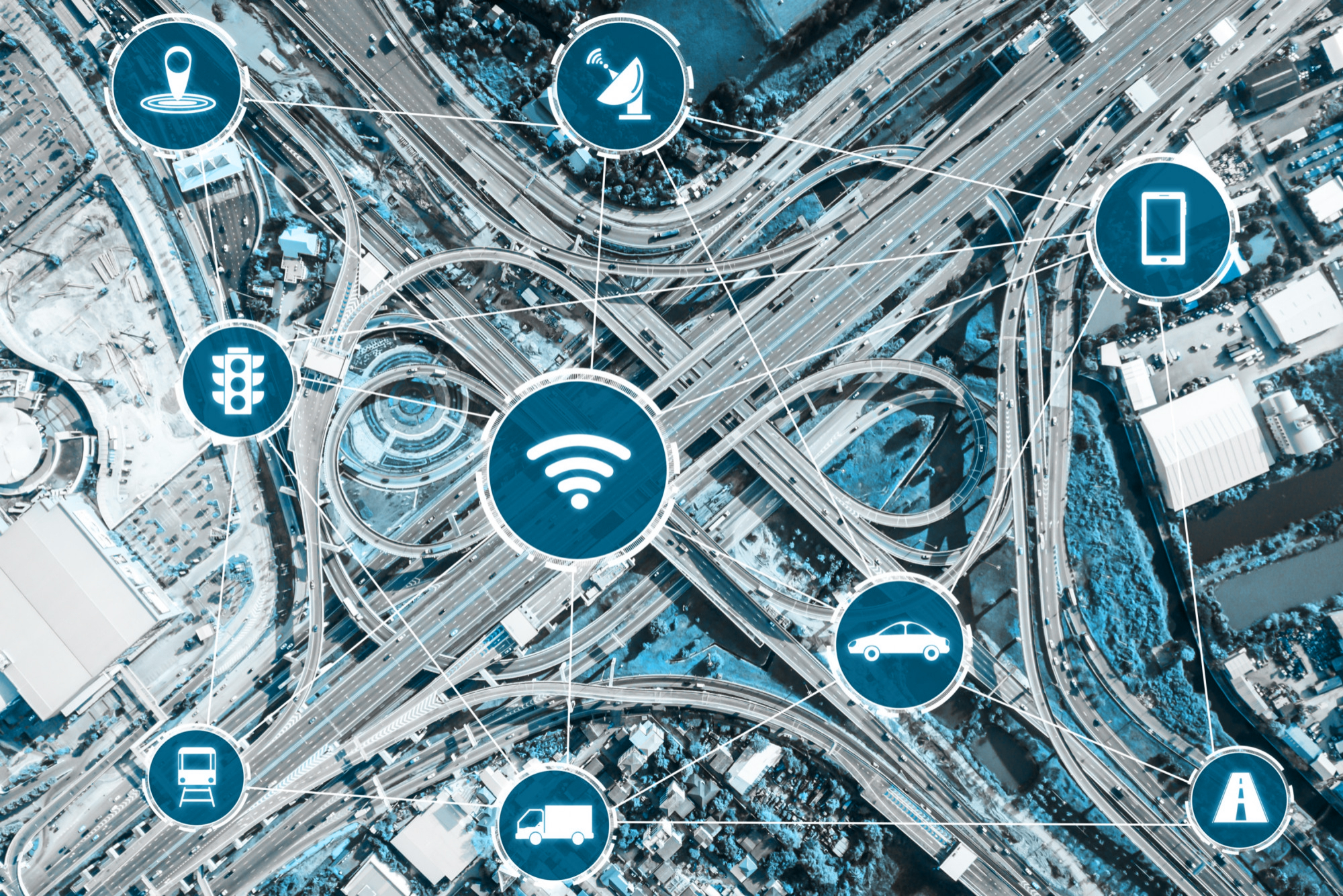 An aerial view of an interconnected smart transportation system powered by IoT and geospatial data. Featuring networked vehicles, traffic management, and wireless communication, this image highlights the future of urban mobility and logistics.